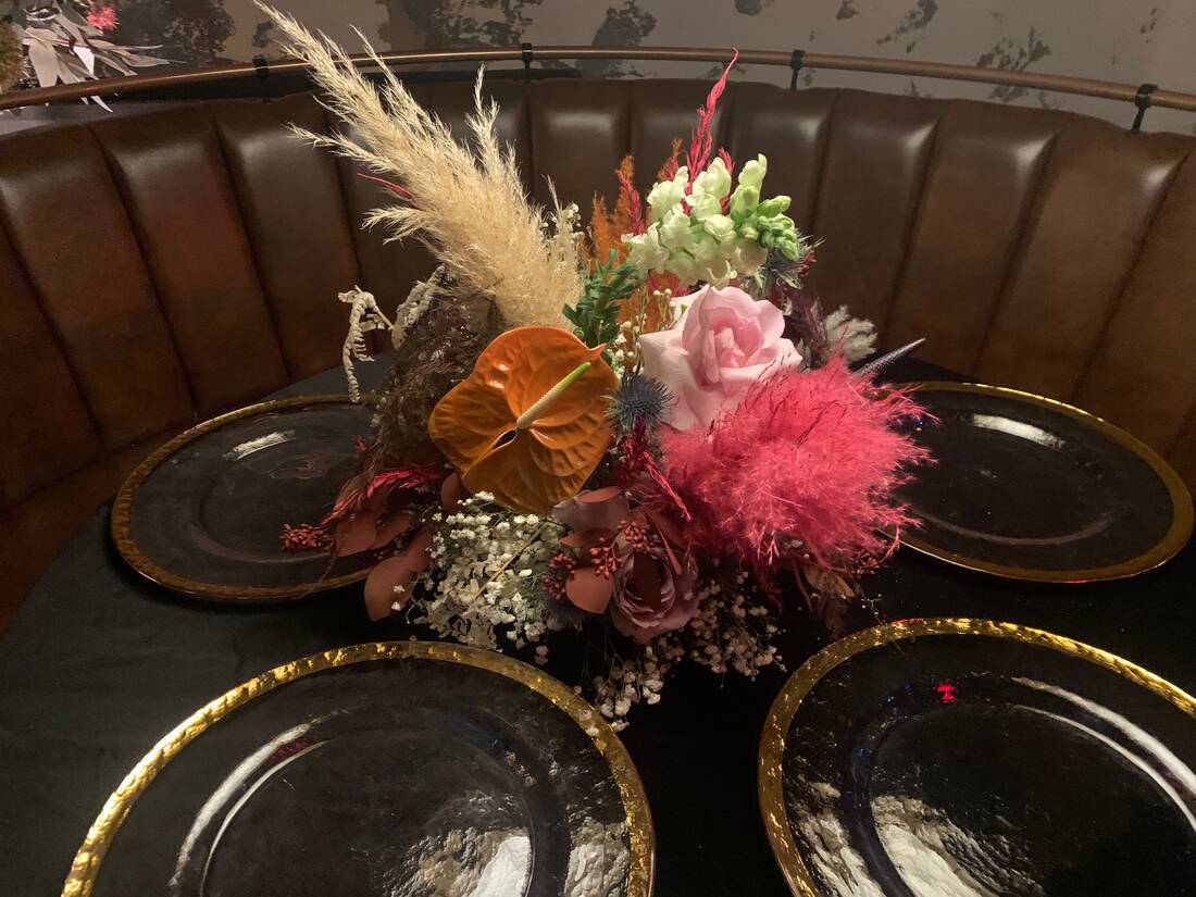 Dried arrangement with pampas grass, anthurium, and preserved roses