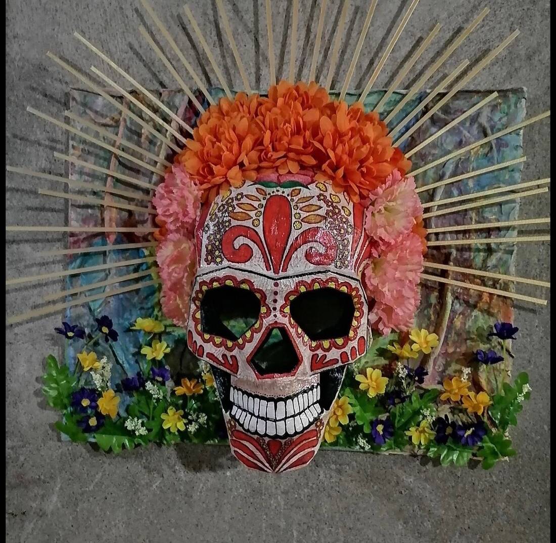 Hand-built sugar skull with marigold crown and radiating rays